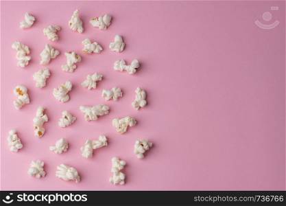 Popcorn on pink background texture