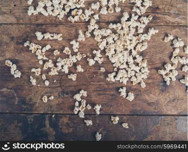Popcorn scattered on a wooden table
