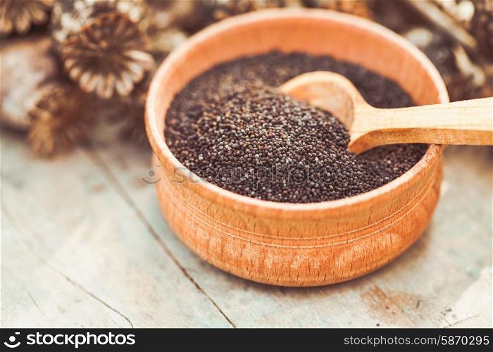 poppy seeds in a wooden bowl on the table. poppy seeds