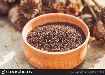poppy seeds in a wooden bowl on the table. The poppy seeds