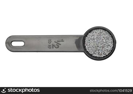 Poppy seeds in measuring spoon on white background