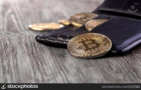 Popular cryptocurrency in leather wallet on wooden table with copy space
