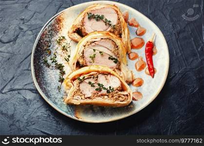 Popular delicious meat food is wellington meat, meat wrapped in dough. British food. Festive food baked Wellington meat.