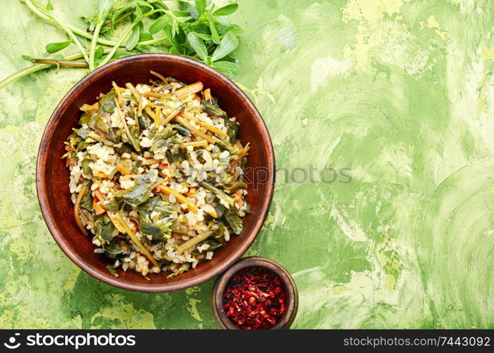 Popular food of the Middle East.Stew bulgur.Bulgur with portulak.. Stewed bulgur with portulak