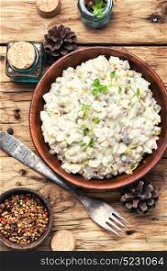 Popular Russian meat salad Olivier. Traditional Russian meat salad Olivier, with meat and vegetables.Flat lay