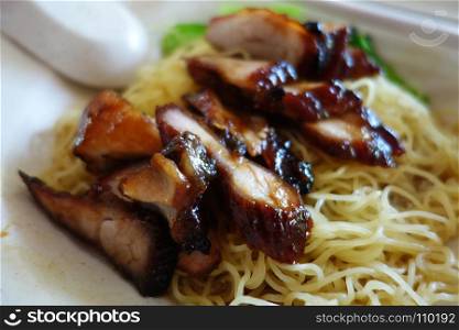 Popular Singapore Chinese street food, wantan mee, kind of noodles serve with bbq pork