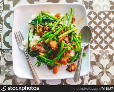 Popular Thai Food one dish meal from Fried morning glory with crispy pork is a delicious for lunch or dinner, Street food