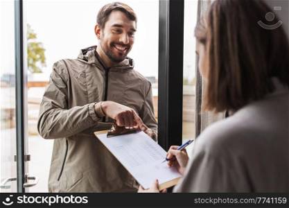 population census, polling and people concept - male social worker asking woman sign papers on clipboard at home. man asking woman to sign papers on clipboard
