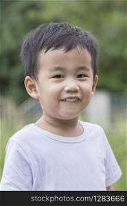 poratriat head shot of toothy smiling face of asian 1 year old children