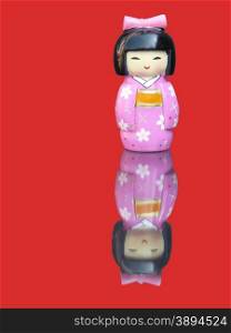 Porcelain chinese figurine with mirror image isolated on red background