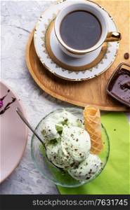 porcelain cup of coffee with pistachio ice cream served at table. life style concept