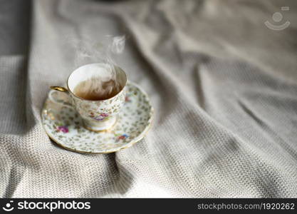 Porcelain tea pot and cup of hot tea on the table, antique traditional crockery set, high tea English afternoon tea cozy stylish interior. Porcelain tea pot and cup of hot tea on the table, antique traditional crockery set, high tea English afternoon tea