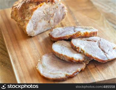 Porchetta - Italian roasted pork on the wooden board