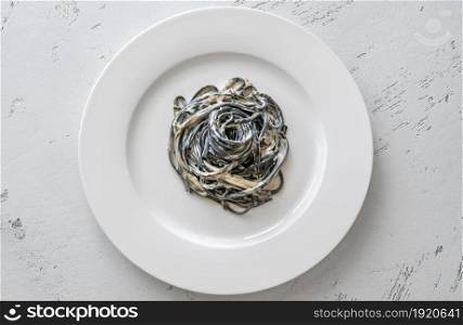 Porion of squid ink pasta with creamy sauce