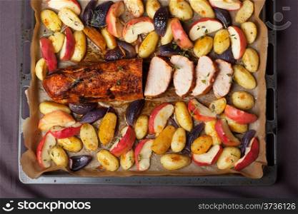 pork baked with vegetables on a tray