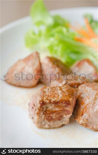 Pork barbecue. grilled pork meat with fresh salad on a plate