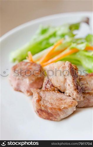 Pork barbecue. grilled pork meat with fresh salad on a plate