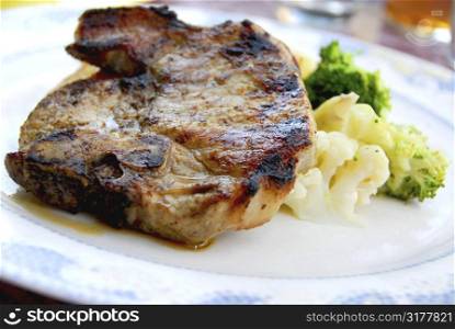 Pork chip dinner with steamed vegetables
