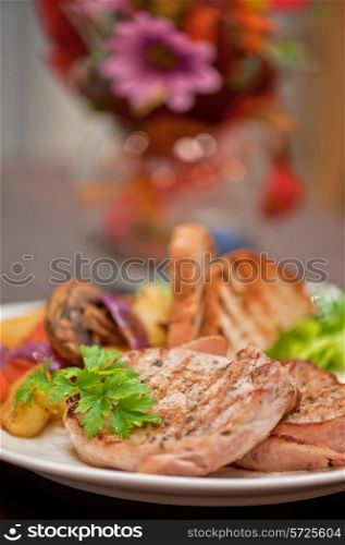 Pork chop with vegetable at plate