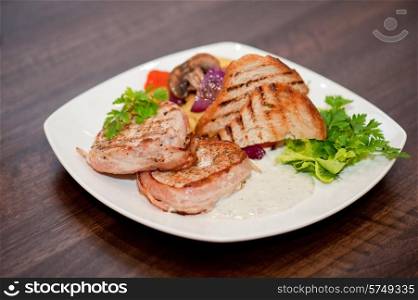 Pork chop with vegetable at plate. Pork chop