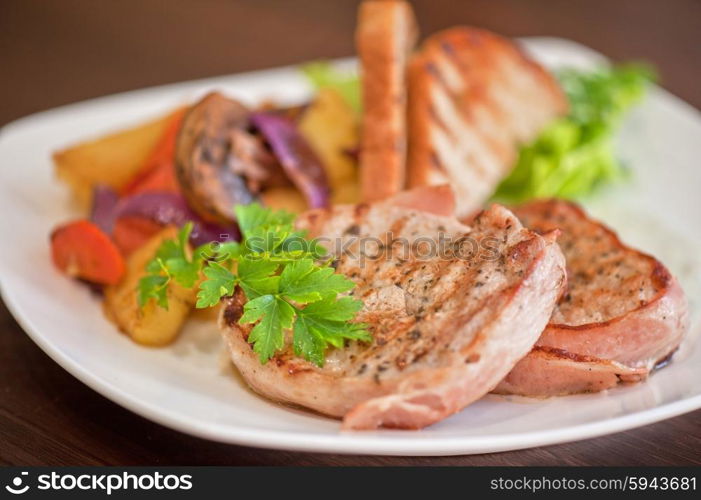 Pork chop with vegetable . Pork chop with vegetable at plate