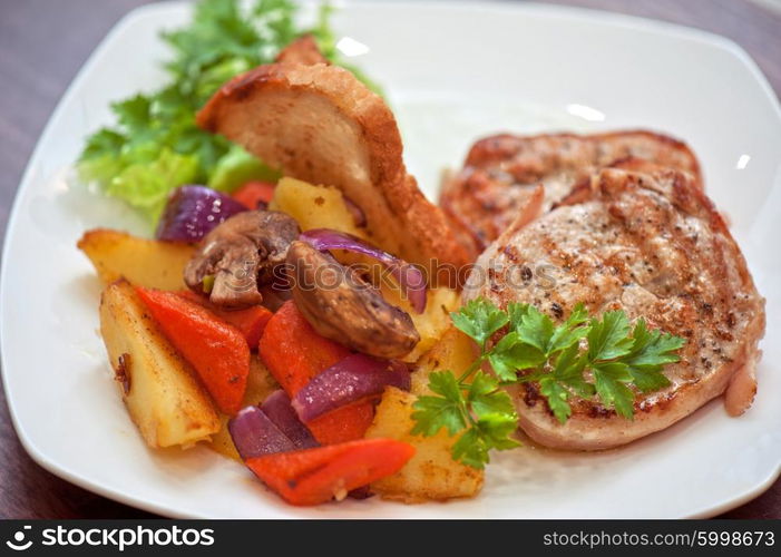 Pork chop with vegetable. Pork chop with vegetable at plate