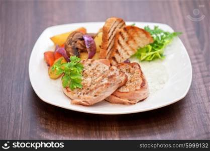 Pork chop with vegetable. Pork chop with vegetable at plate