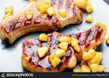 Pork entrecote cooked with aromatic autumn apples.Appetizing meat with caramelized apples.. Meat steak with apple sauce
