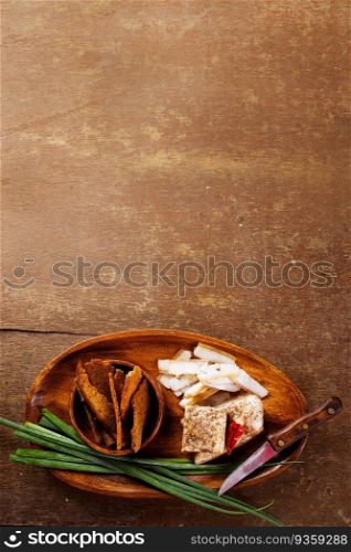 Pork fatback with spices, rye bread and green onion on wooden table