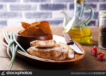 Pork fatback with spices, rye bread and green onion on wooden table