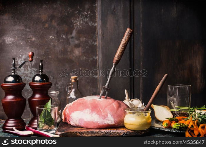 Pork Ham meat with Honey Mustard Glaze and ingredients, preparation on aged kitchen table at dark rustic wooden background, side view, place for text