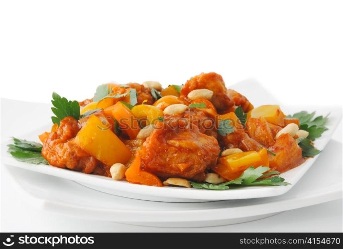 Pork in batter with pineapple and bell pepper in sweet and sour sauce with peanuts