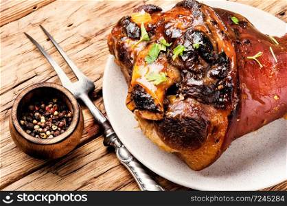 Pork knuckle on rustic table.Oktoberfest menu.Baked pork knuckle. Roasted pork knuckle with spices