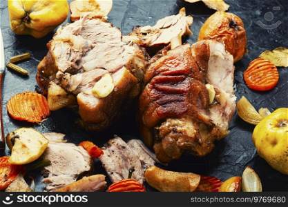 Pork knuckle stewed with quince and apples.Autumn meat recipe. Pork leg grilled with apples