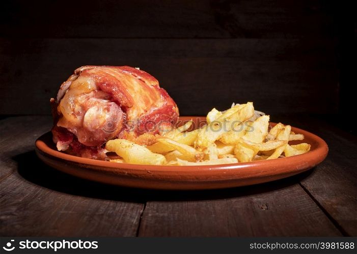 Pork Knuckle with Sauerkraut and fried Potatoes. High quality photography.. Pork Knuckle with Sauerkraut and fried Potatoes