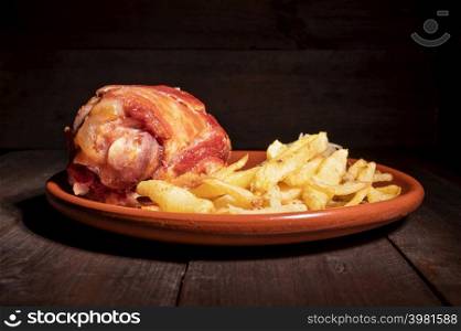 Pork Knuckle with Sauerkraut and fried Potatoes. High quality photography.. Pork Knuckle with Sauerkraut and fried Potatoes