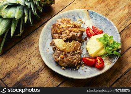 Pork meat grilled with pineapple and cheese. Meat cooked with pineapple