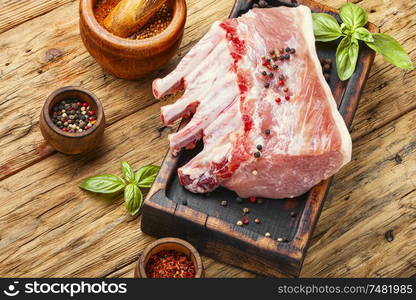 Pork meat on chopping board ready for cooking. Pork rack on cutting board