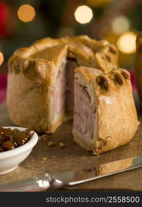 Pork Pie cut on a Board with Chutney