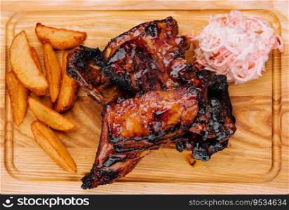 Pork ribs with baked potatoes and cabbage salad