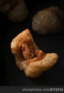 Pork rind is the culinary term for the skin of a pig. It can be used in many different ways. Close-up shot pork rinds.