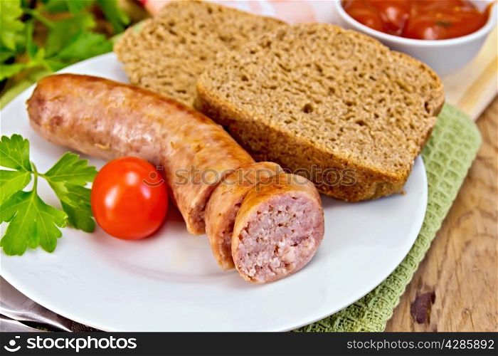 Pork sausages grilled in the plate on a napkin, bread, sauce, tomato, parsley on a wooden boards background