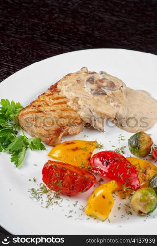 pork steak with mushroom sauce and grilled vegetables