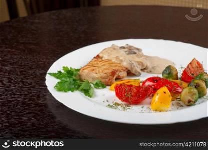 pork steak with mushroom sauce and grilled vegetables
