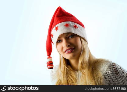 porrait of beauty blond woman with christmas hat and sweater smiling