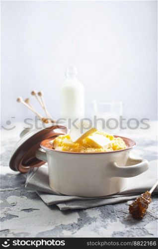 porridge with butter in plate on rustic table.. porridge with butter in plate on rustic table