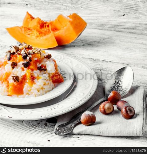 Porridge with pumpkin in stylish wooden bowl, rustic