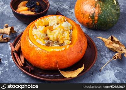 porridge with pumpkin. Pumpkin rice porridge cooked in pumpkin on autumn background