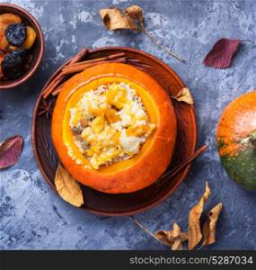 porridge with pumpkin. Pumpkin rice porridge cooked in pumpkin on autumn background