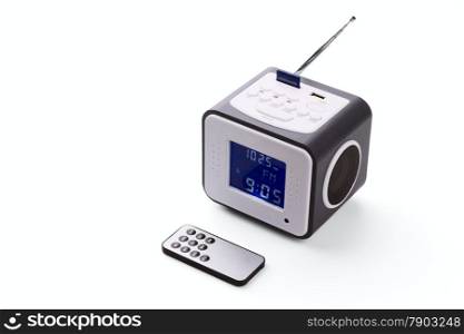 Portable radio receiver with alarm, card-reader, amplifier, remote control and MP3 player isolated on a white background